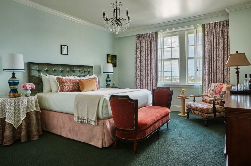 A shot of the room inside the pontchartrain hotel, the bedding and curtains are several shades of pink, giving the room a soft feeling
one of the best boutique hotels in new Orleans