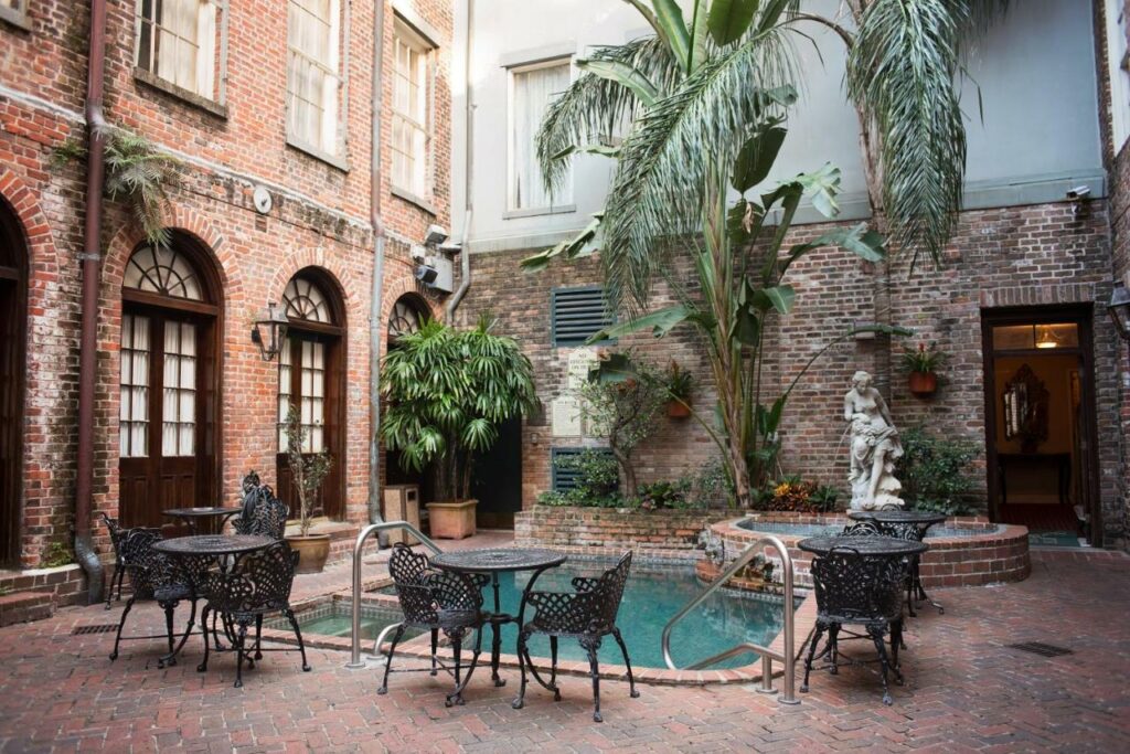 An interior daytime shot of the pool area at Quarter house New Orleans One of the best boutique hotels in New Orleans