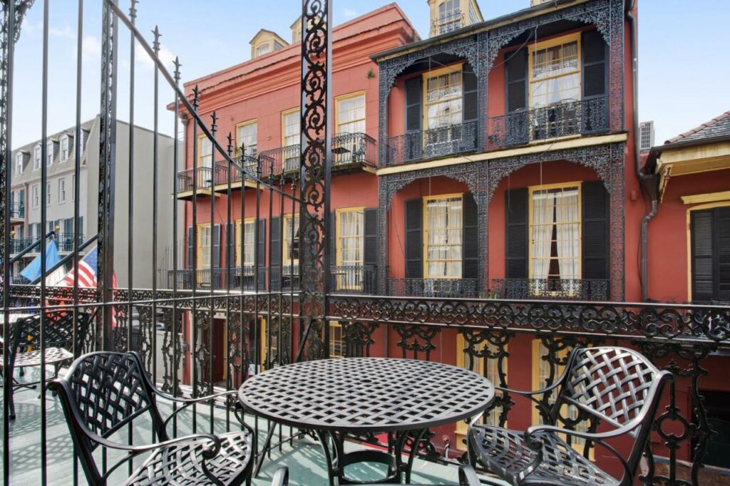 A picture of the balcony at hotel st Marie looking directly down into the French quarter of New Orleans 