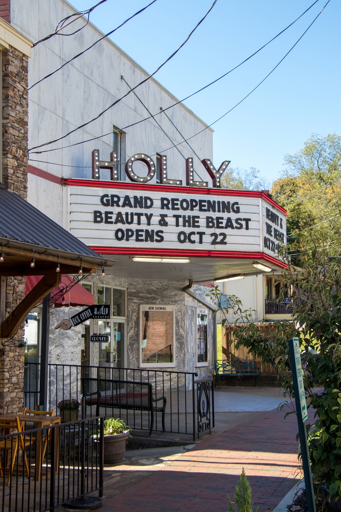 The marquee over the entrance of the historic Holly Theatre advertises their grand reopening show after extensive renovations.