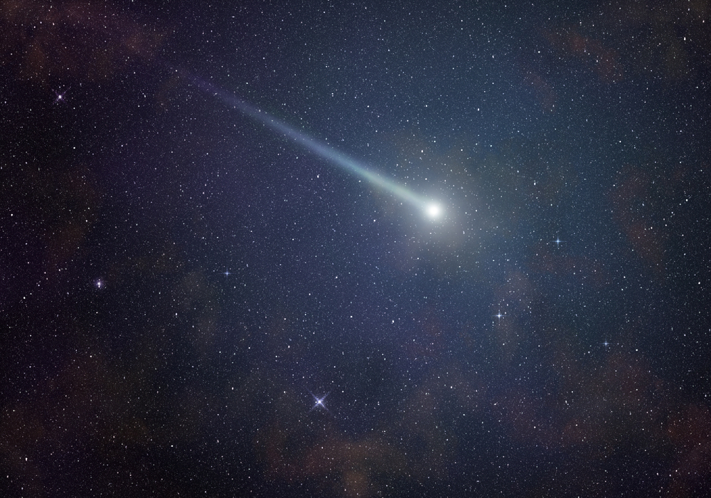 Shining comet in a starry night sky.