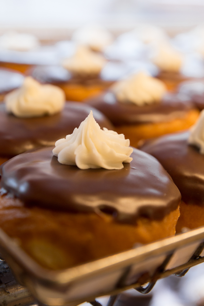 flips flops donuts, one of the best things to do in emerald isle NC. a tray of many Boston creme donuts