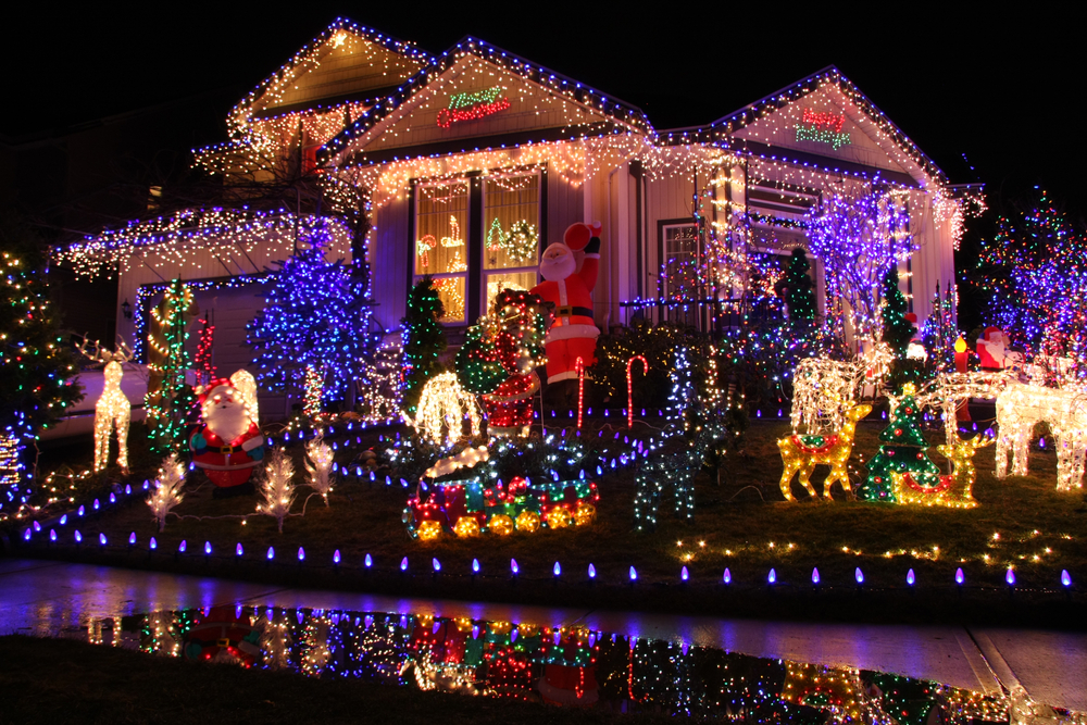 house with lights on it as well as other holiday decorations
