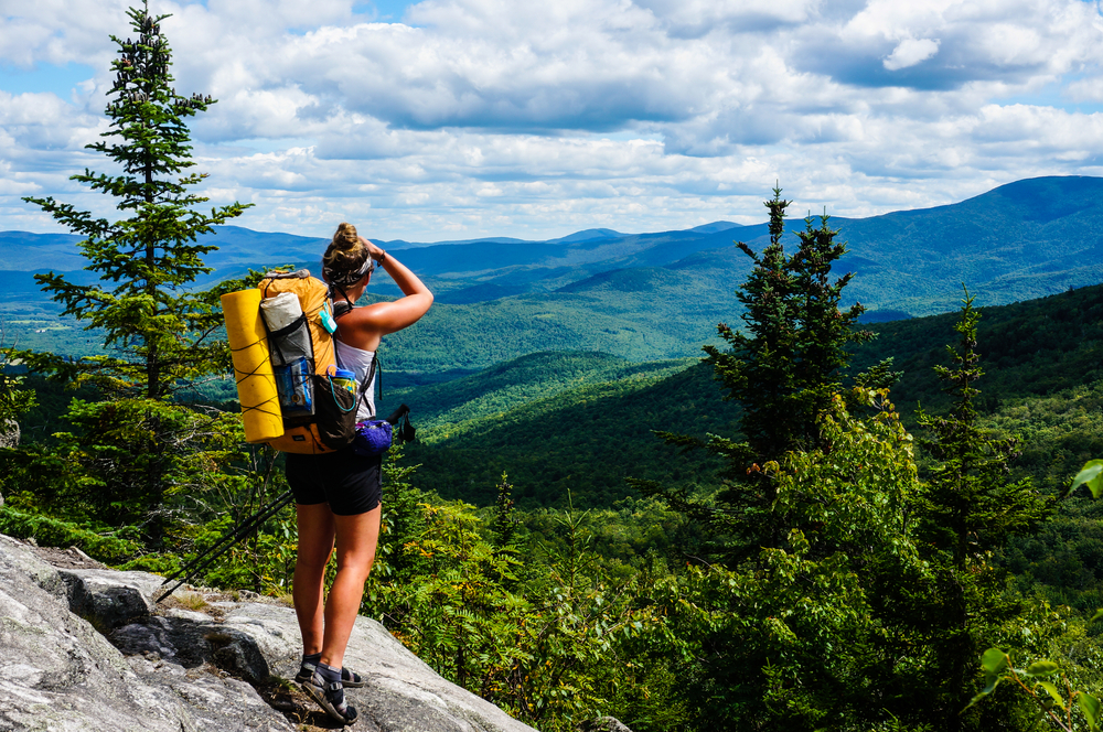 Girl looking over the blue mountains while hiking the Appalachian Trail 