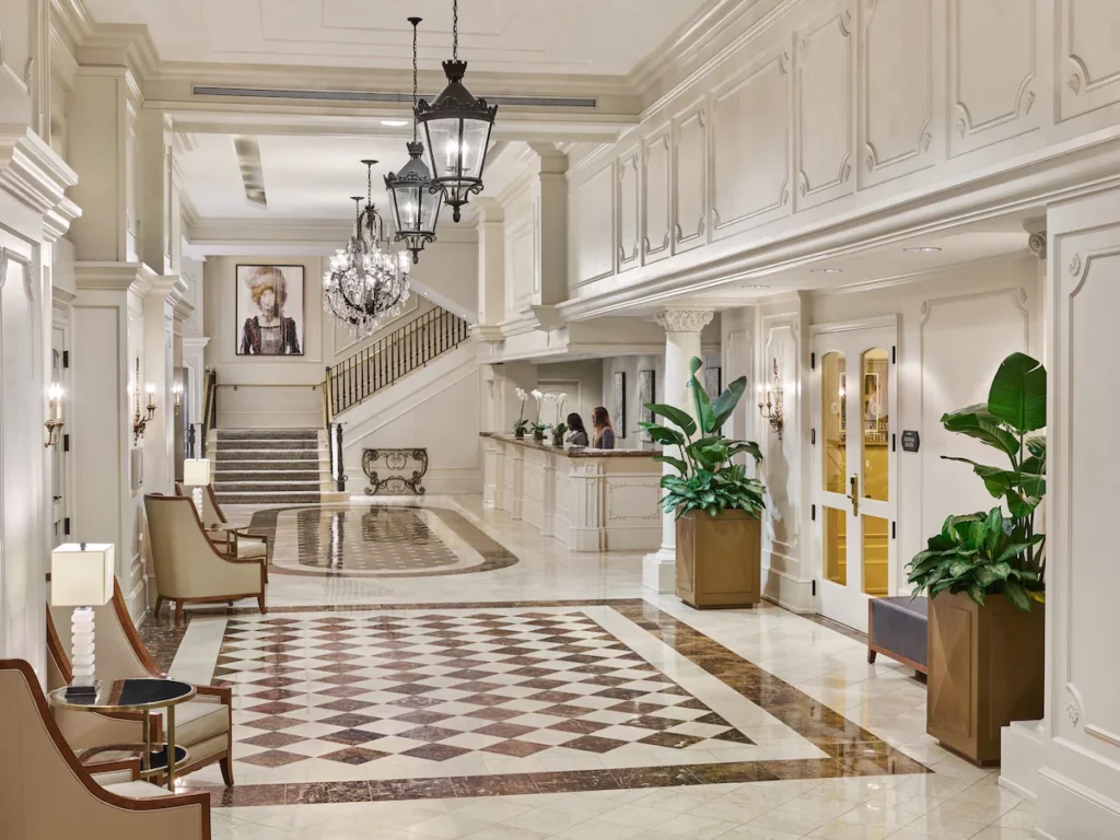 A classic, shiny and modern indoor lobby featuring classic marble flooring and plant furnishings welcoming you into this option for haunted hotels in New Orleans