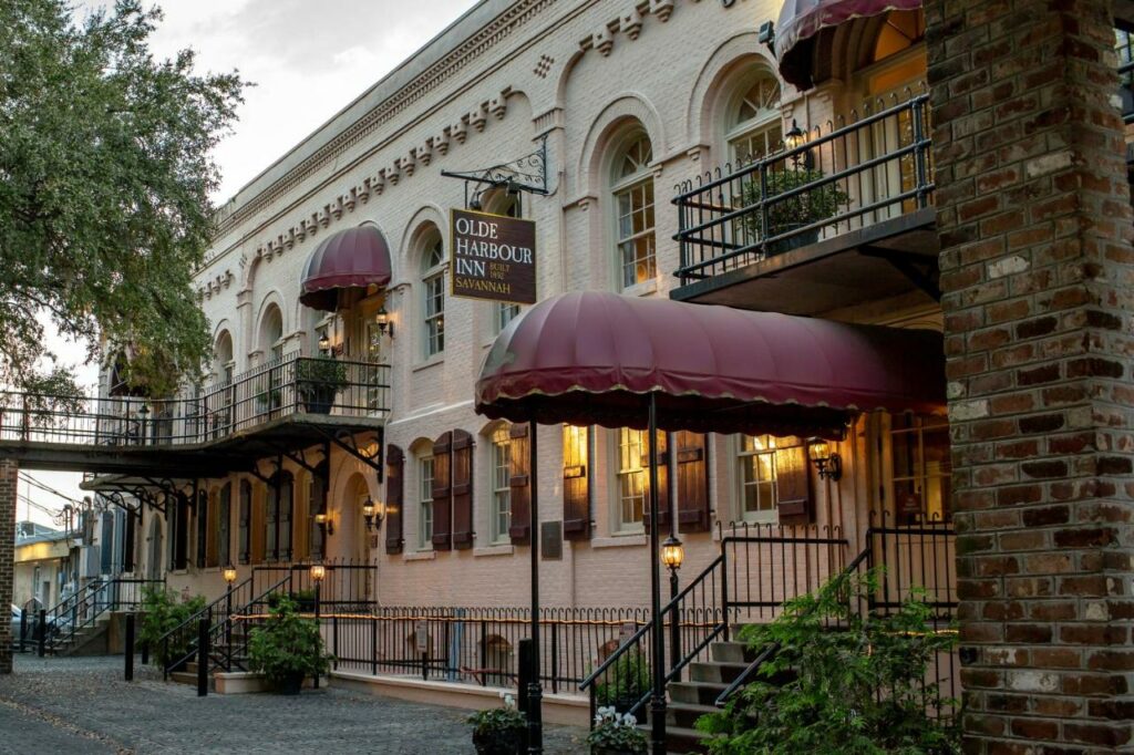 outdoor view of a classic historical building with traditional hotel fabric awnings and brick exterior