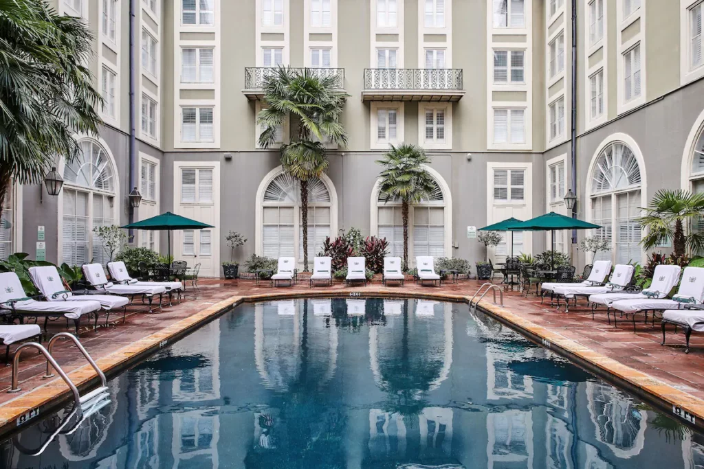 some beautiful rounded arched windows and clean outdoor pool-area is an amazing option for the most haunted hotel in New Orleans