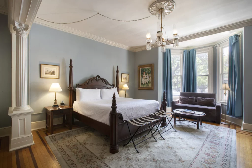 a beautiful room with classic furniture and blue accents to tie it all together, a great one of our options for haunted hotels in Savannah
