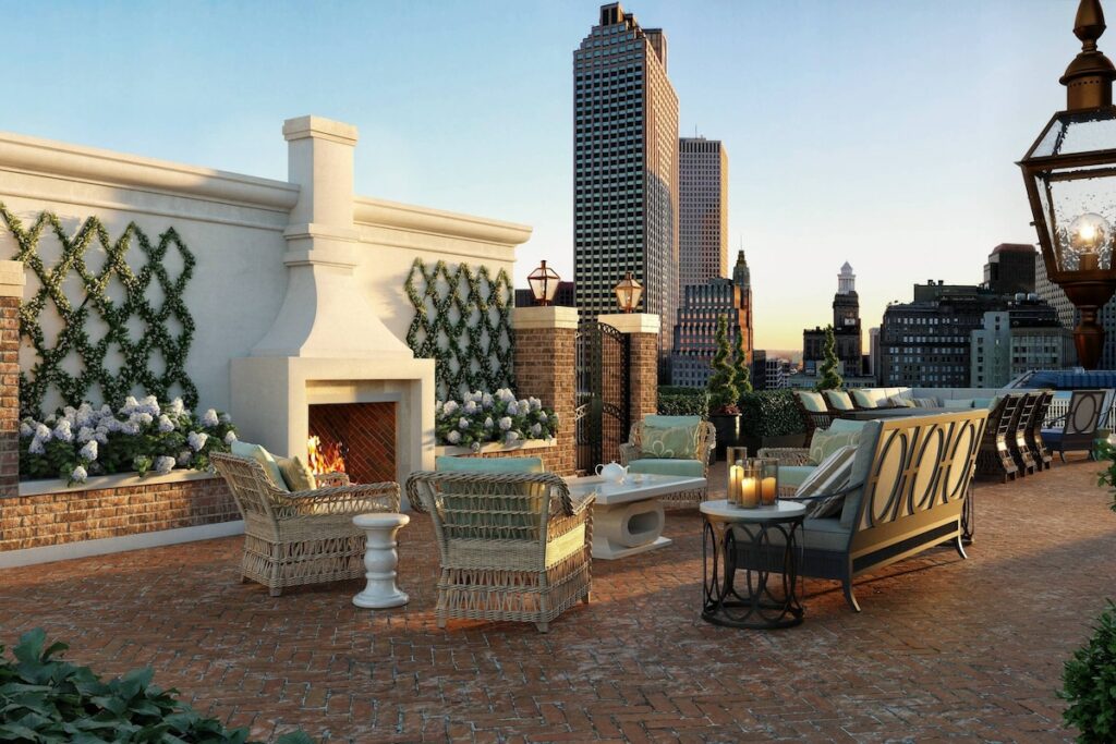 photo of the rooftop deck at the Ritz Carlton with an outdoor fireplace and furniture 