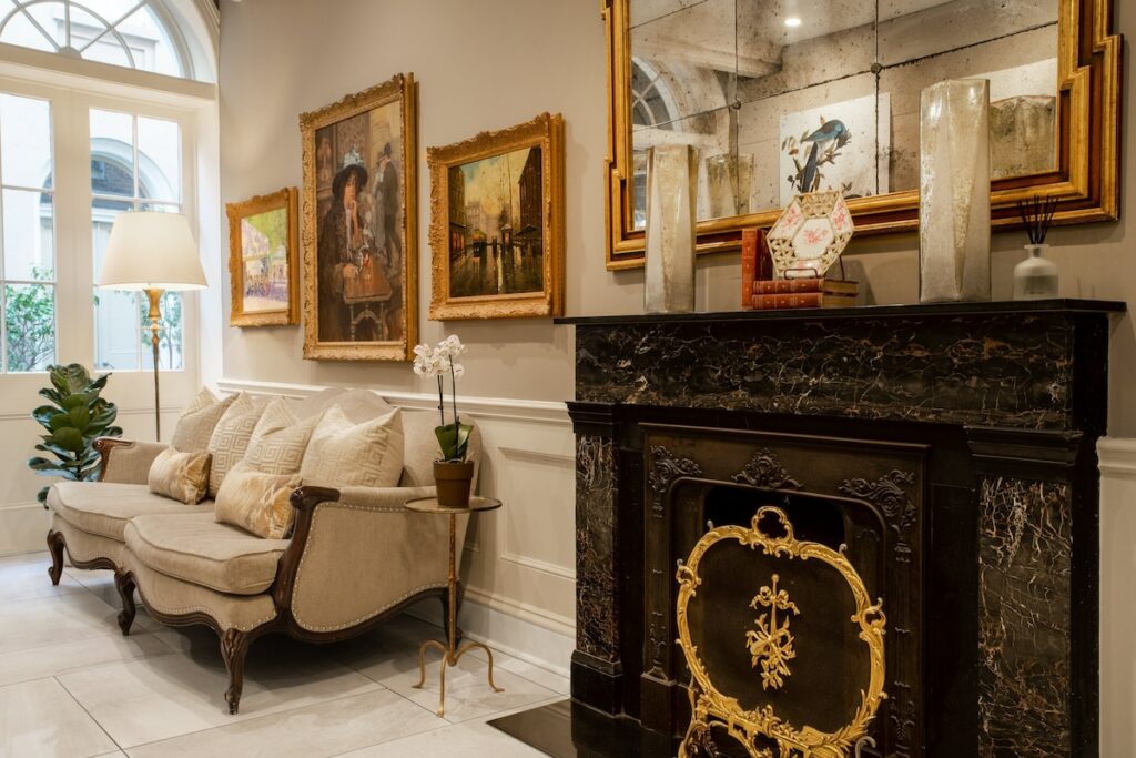 photo of a fireplace and paintings in a common area at voco saint James 