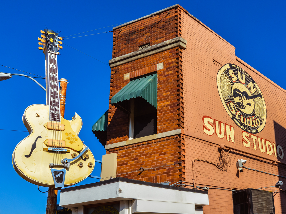 The front exterior of the Sun Studio which is a narrow brick building with a giant yellow guitar on the outside of it, one of the best things to do during a weekend in Memphis. 