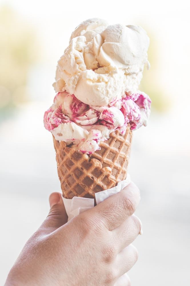 hand holding ice cream cone with two scoops