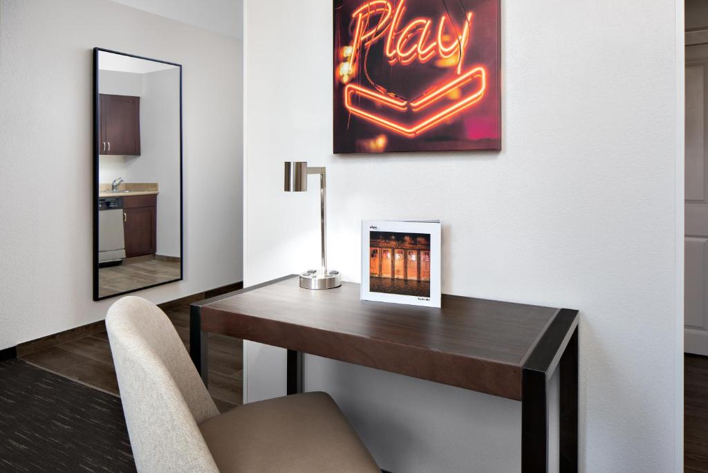 A desk with a chair and mirror that sits below a classic "Play" sign that you would see at the Music City Hall-- a place you have to visit even when just looking for where to stay in Nashville. 