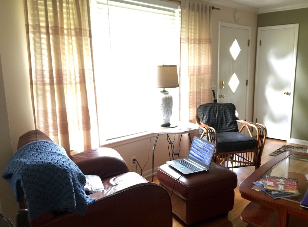 Rentals may be where to stay in Nashville when considering pricing-- this small rental is perfect for a visit, and its comfortable living room features a great big window, chairs, coffee tables and more. 