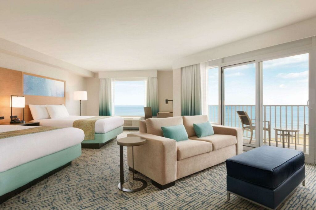 Pretty view of the ocean with two queen beds and a comfy couch in Virginia Beach 