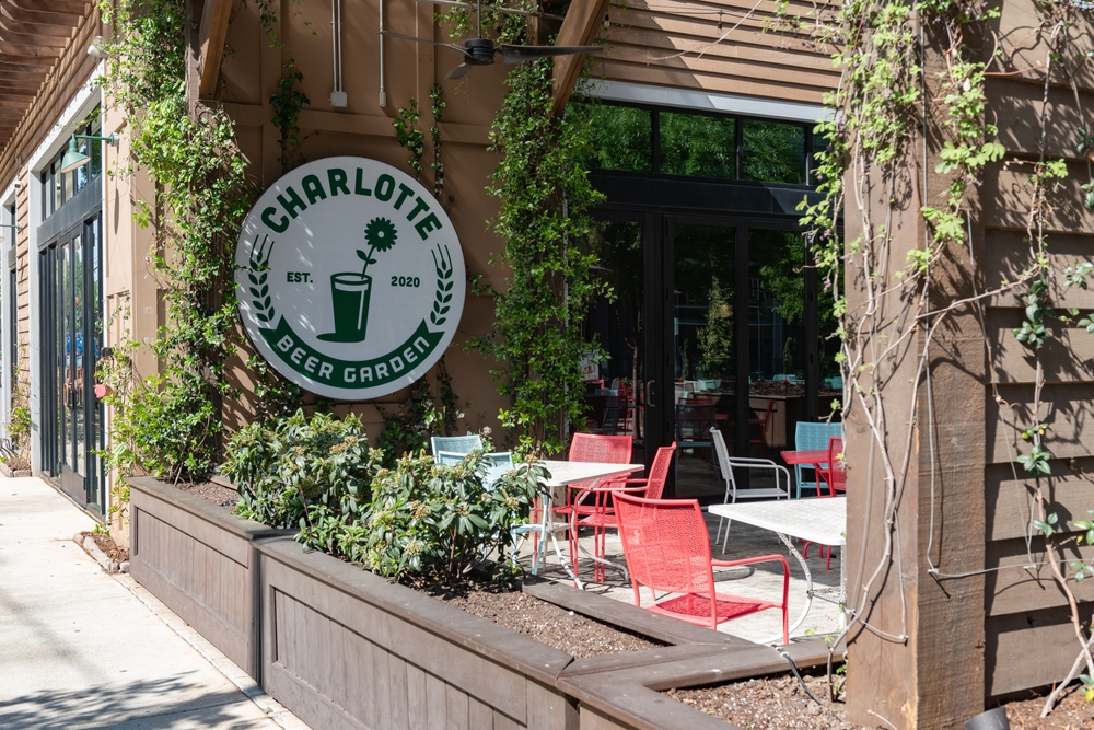 exterior of Charlotte beer harden, one of the best places for beer in north carolina, chairs and tables in courtyard