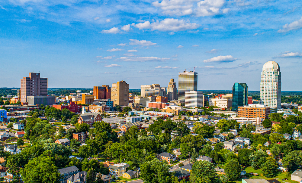 aerial photo of Charlotte skyline with trees in the foreground, best city for beer in north carolina