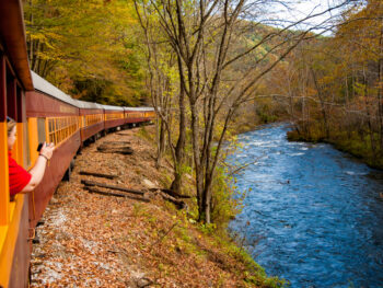 train driving around a river one of the best things to do in bryson city NC