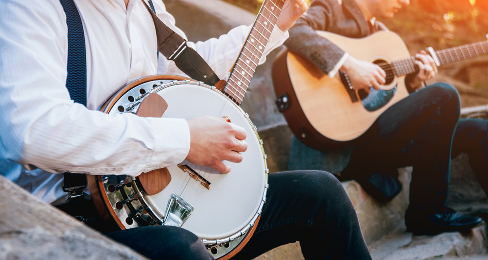 Photo of artists playing a folk music on a banjo and guitar in Mountain View Arkansas. 