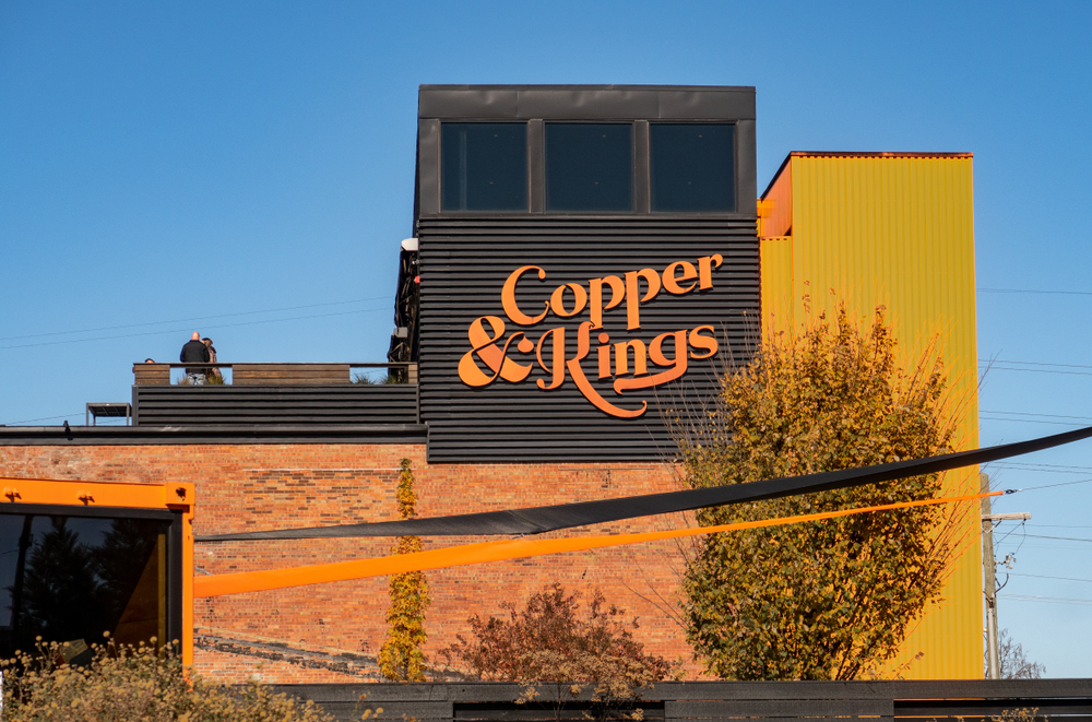 cooper and kings sign and building on a sunny day, one of the best distilleries in louisville