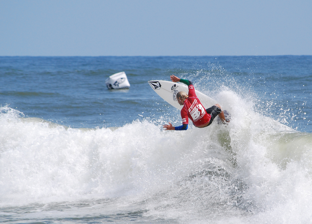 surfer in the water wearing a red ecsc shirt 