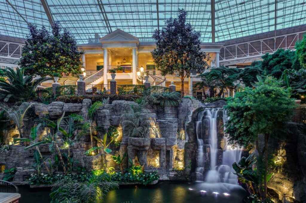 At one of the best resorts in Tennessee, Gaylord Resort & Convention Center is held under a glass atrium and has stunning waterfalls and plants all around, as seen in this photo. 