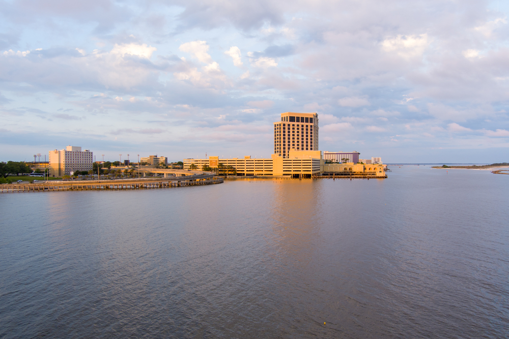 One of the best things to do in Biloxi, the Beau Rivage Resort and Casino stands on the water at sunset.
