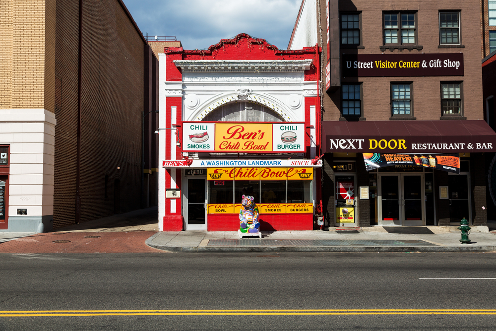 The front exterior of Ben's Chili Bowl a red, white, and yellow building that is over 60 years old and still looks very retro