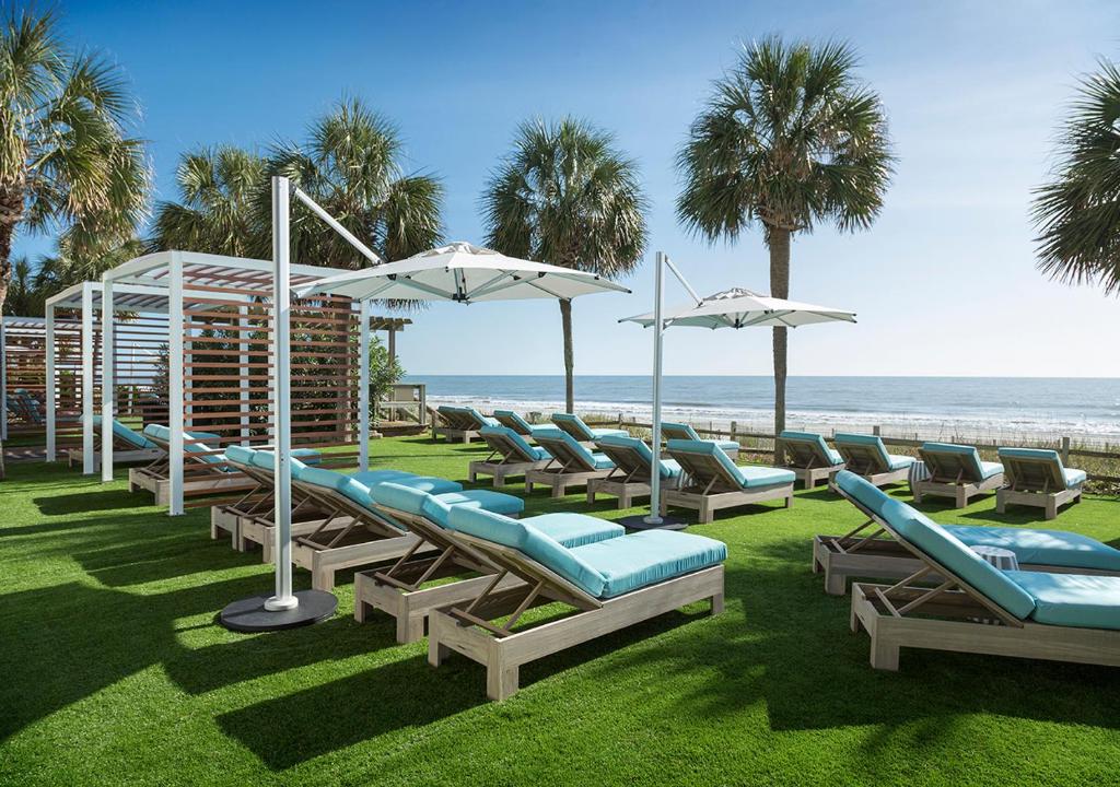 the outdoor  area with chairs overlooking the ocean 