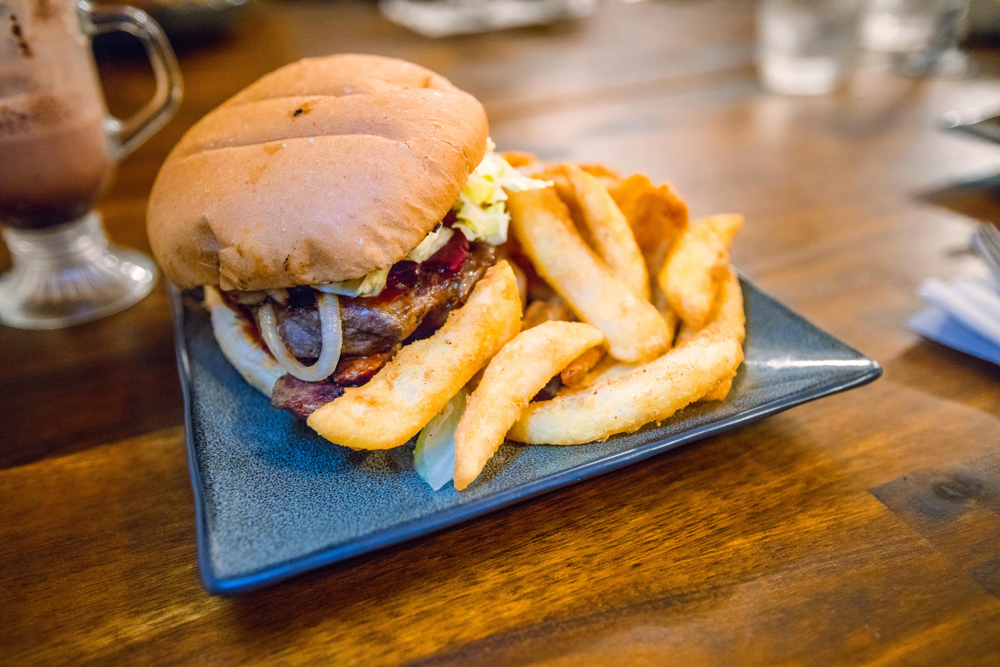 a square plate with a burger and french fries on it 