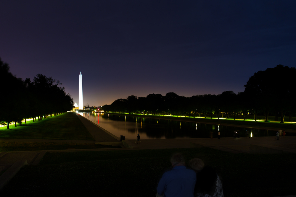Looking down the reflecting pool at the Washington Monument at night, one of the best things to do in Washington DC at night