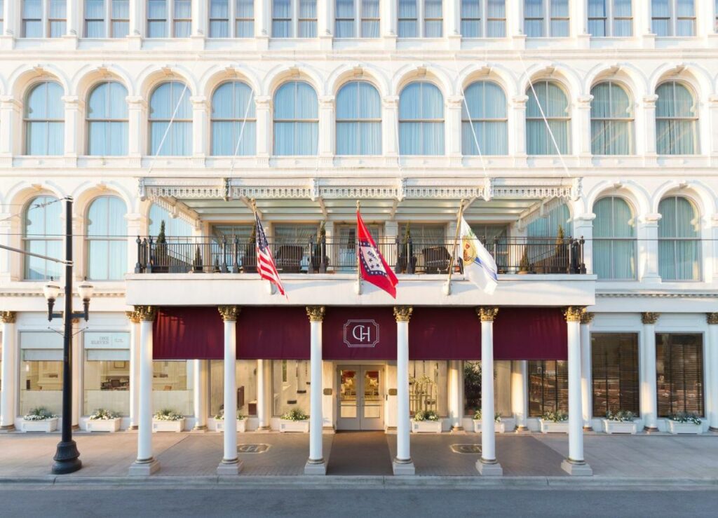 outside of hotel on street, three flags flying out front, one of the best resorts in arkansas 