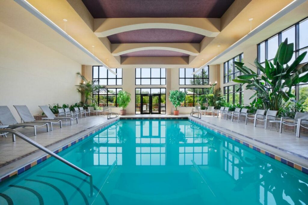 large indoor pool with lounge chairs all around it 