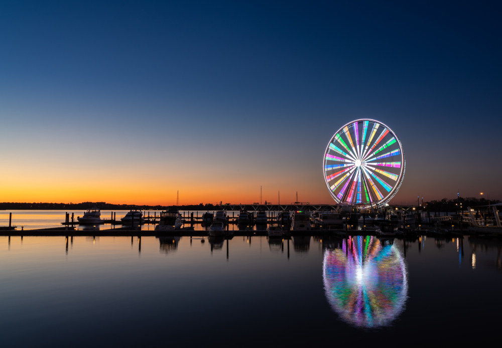 A view of the National Harbor and the lit up Capital Wheel as the sun is setting