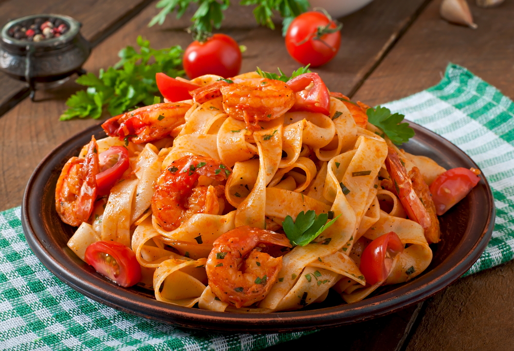 A big fresh plate of shrimp pasta with tomatoes at one of best restaurants in Arlington