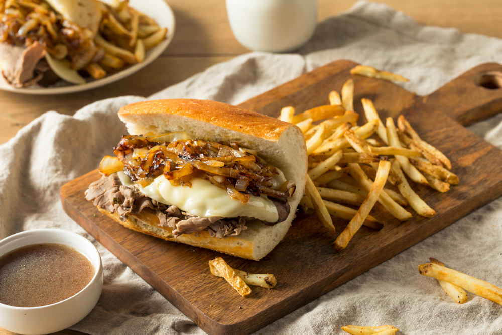 French die with French fries and a dipping sauce 