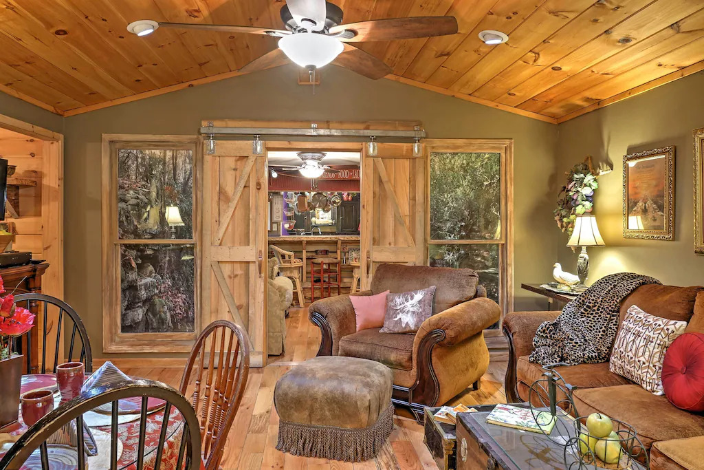 view of the cozy green paint and wood paneled ceiling of the living room of the romantic cottage 