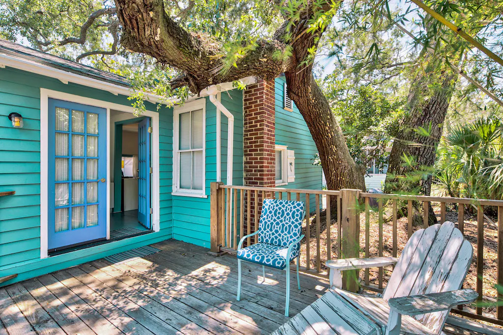 View of the lovely deck and teal blue exterior of the Vintage Cottage