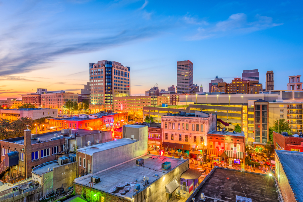 photo of Memphis TN at sunset with the city lights glowing from the bottom of the image 