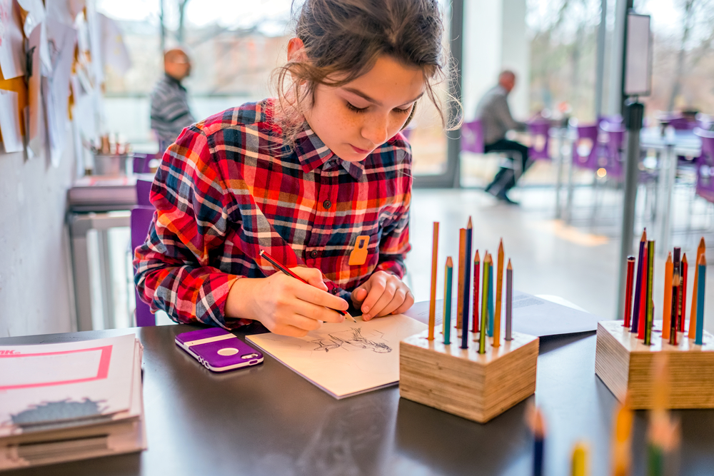 a girl coloring inside of a museum in Washington DC 