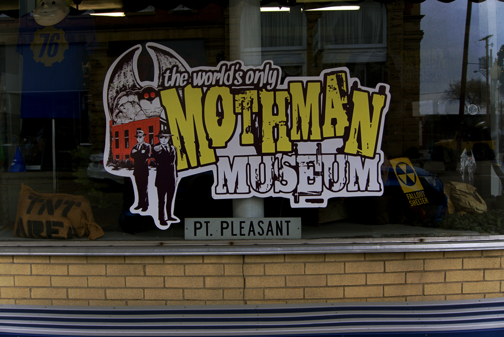 a sign on a window that says the worlds only mothman museum