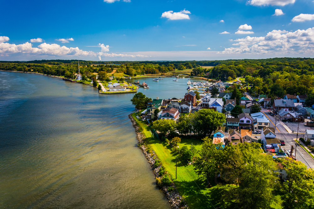 aerial photo of watefront town and small harbor 