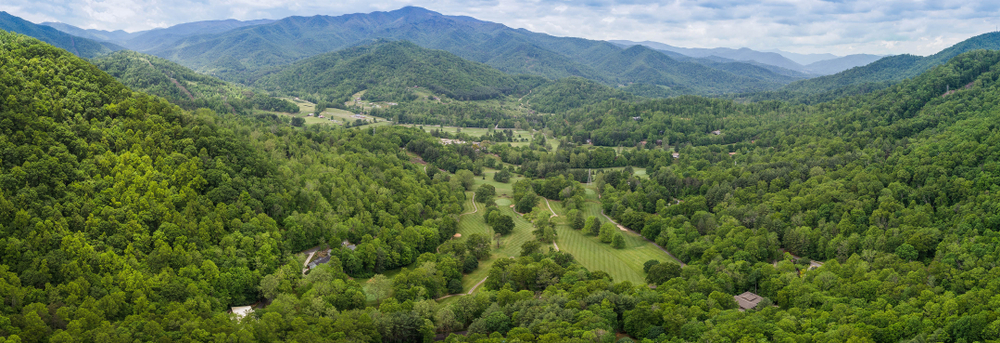 aerial image of the golf course at maggie valley club and resort, nestled between the blue ridge mountains and great smoky mountains!