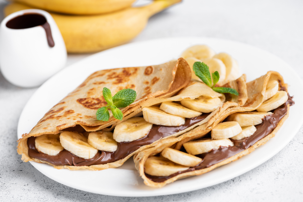 Nutella and banana seep out of the ends of this crepe, 