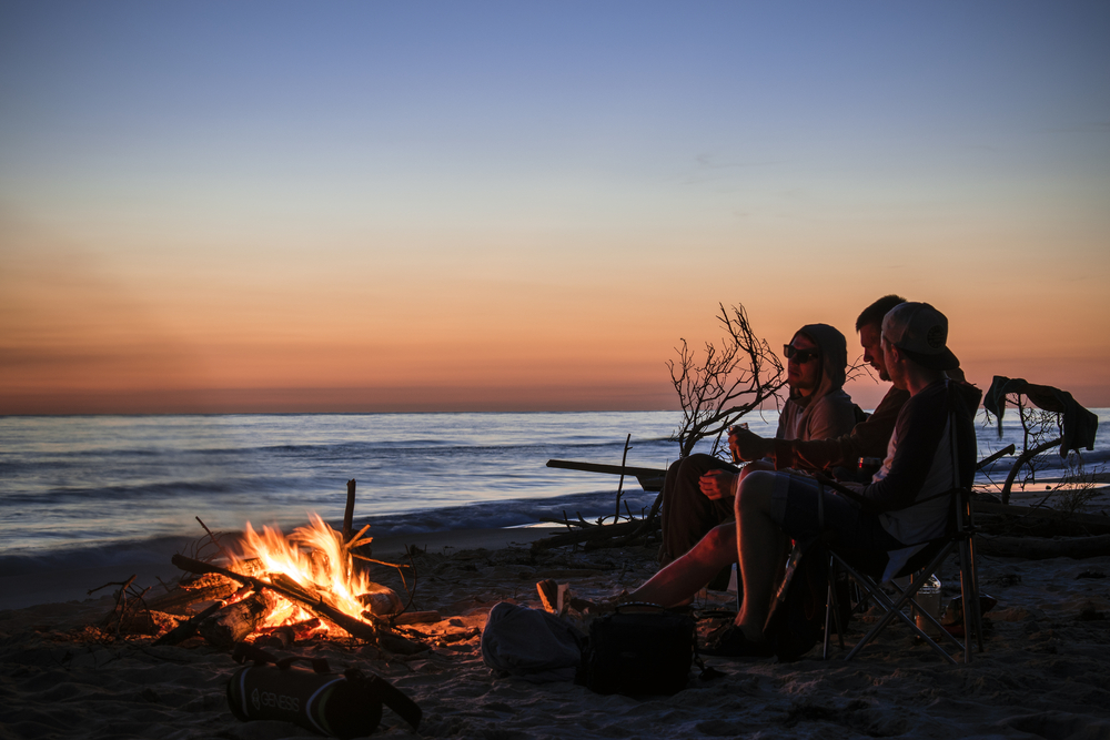 a group of campers hanging out on one of the best beaches in Maryland 