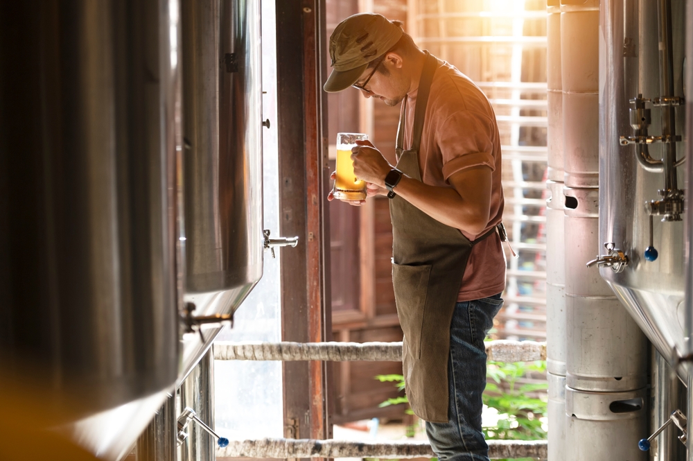 a man tasting beer in a craft brewery 