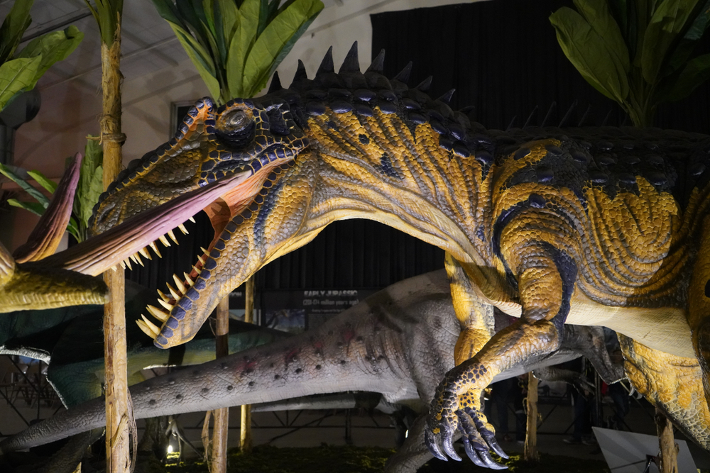 Photo of a dinosaur statue with its mouth open, showing teeth, at Jurassic Quest, one of the best things to do in conroe 