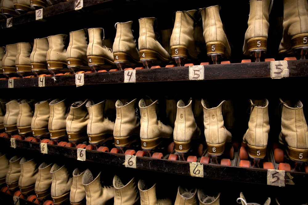 photo of roller skates lined up on a shelf, something you can find at Rainbow Roller Rink, one of the best things to do in Conroe 