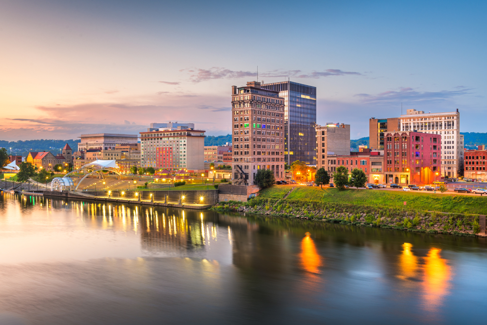 cityscape on rivers edge just before dark, lights have begun to turn on