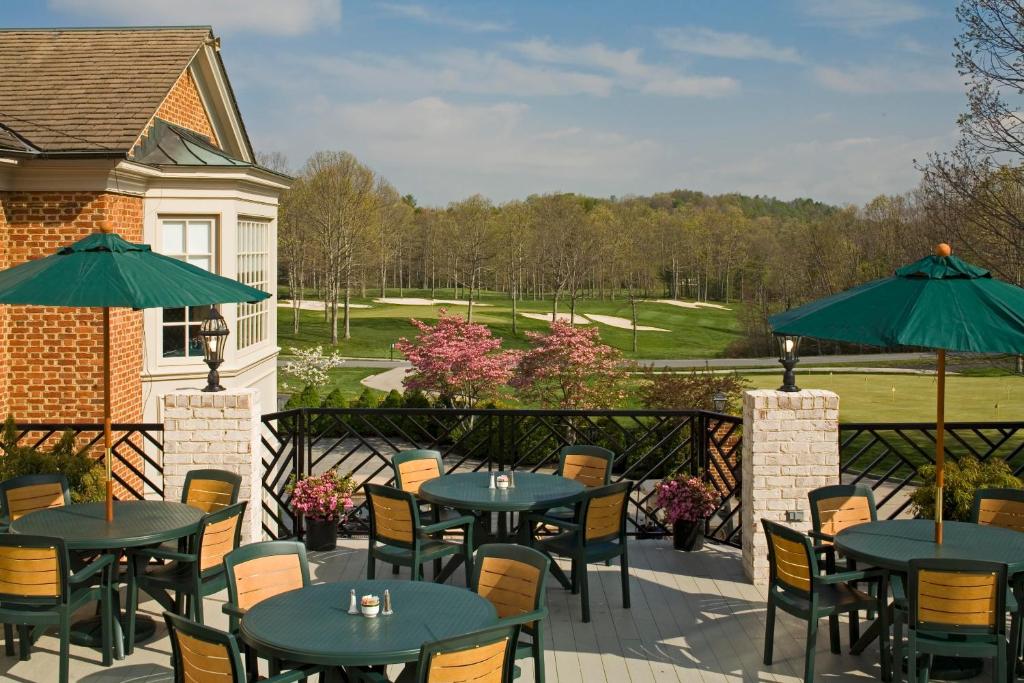 tables and chairs on a patio overlooking a golf course at a resort in WV
